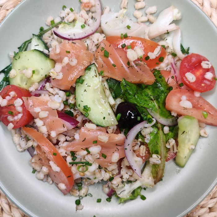 Organic spelt salad with salmon, cucumber, and tomato