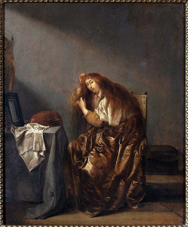 Woman in front of the mirror by Pieter Codde
