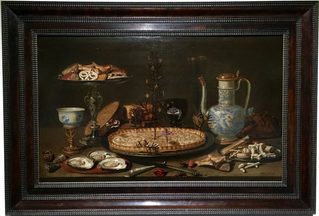 Still life of pie and sweets with stoneware jug by Clara Peeters