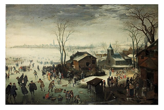 Winter: a landscape with elegant figures skating and boys fighting with snowballs in the foreground, beside a village and a view of Antwerp in the distance beyond by Jan Wildens