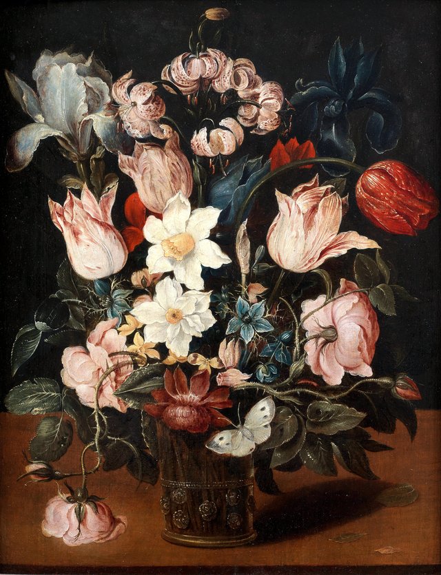 Tulips, narcissi, an iris and other flowers in a glass vase on a table top with a butterfly by Osias Beert