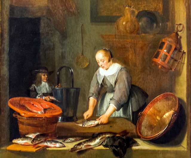 Interior with a woman cleaning fish and a boy with a fish by Quirijn van Brekelenkam