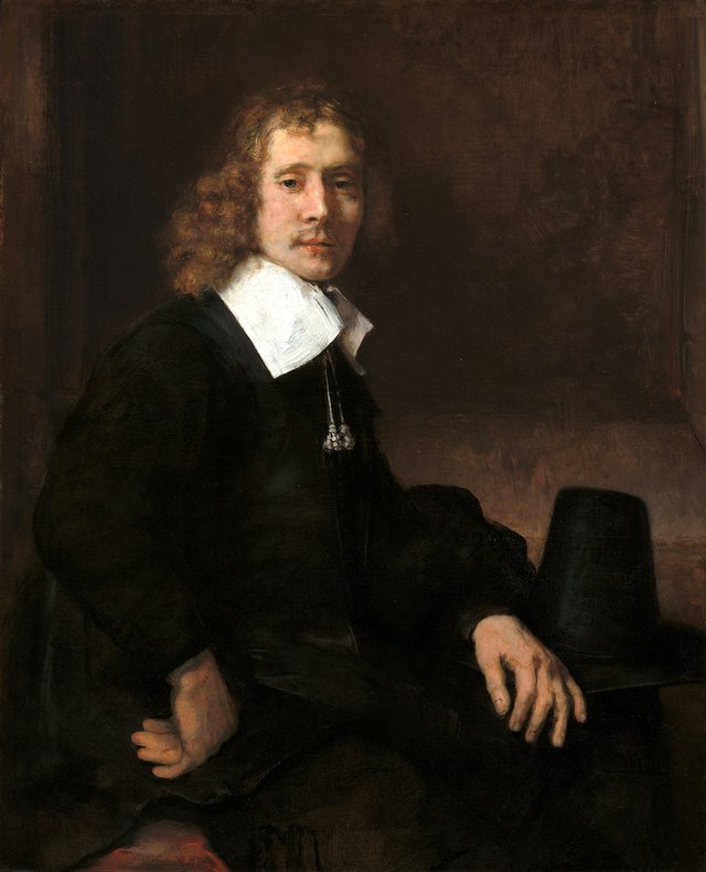 A Young Man Seated at a Table (possibly Govaert Flinck) by Rembrandt