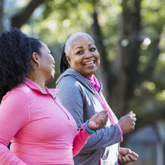 Two women walking and laughing resized