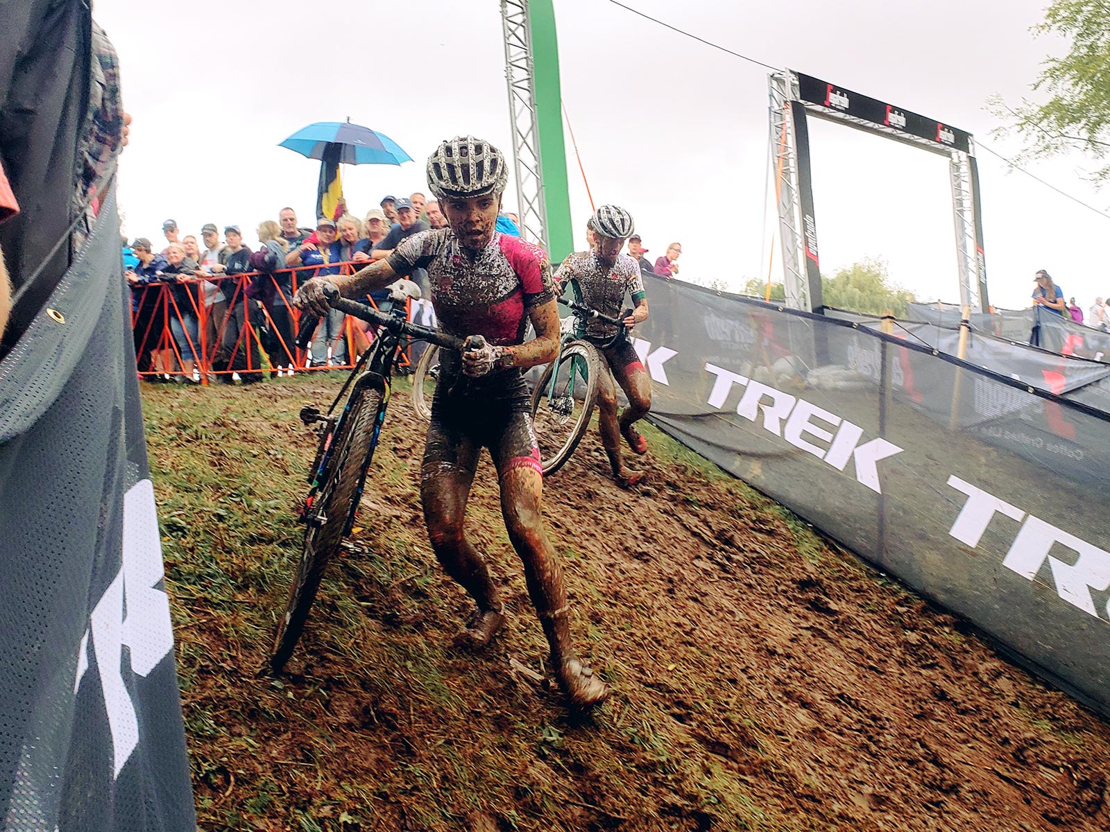 Two cyclocross racers descend a muddy hill at the Trek CX Cup in 2019.