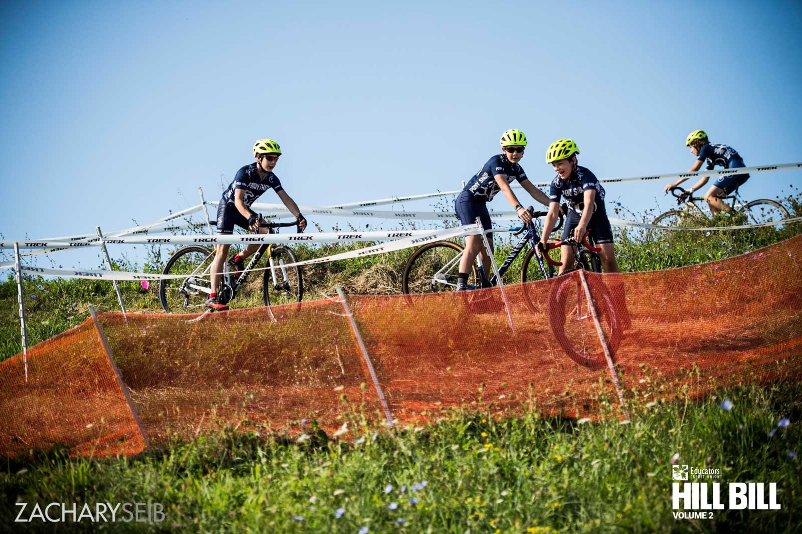 Youth cyclocross racers navigating an off-camber descent.