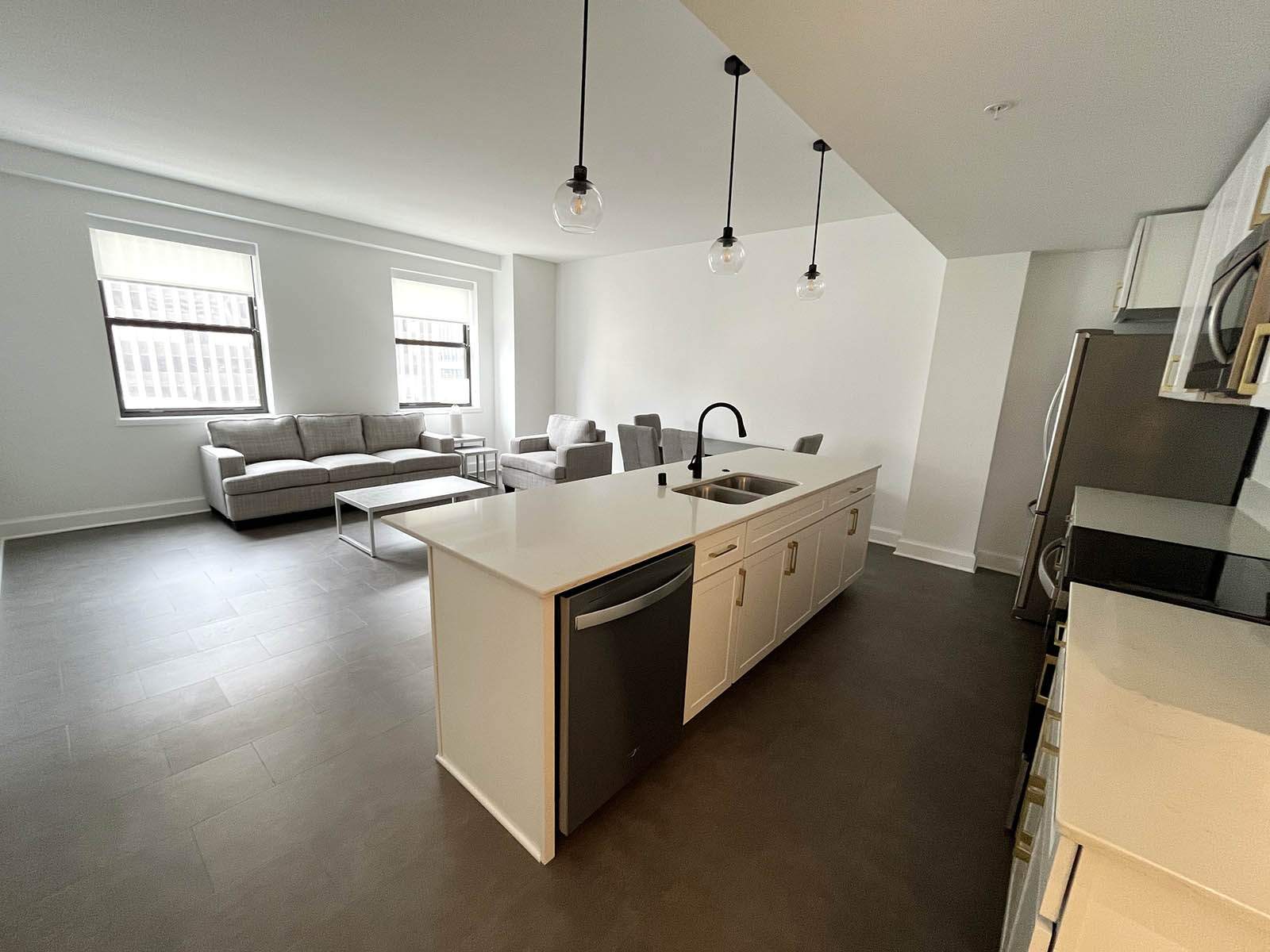 An open plan kitchen and living room in a one-bedroom unit.