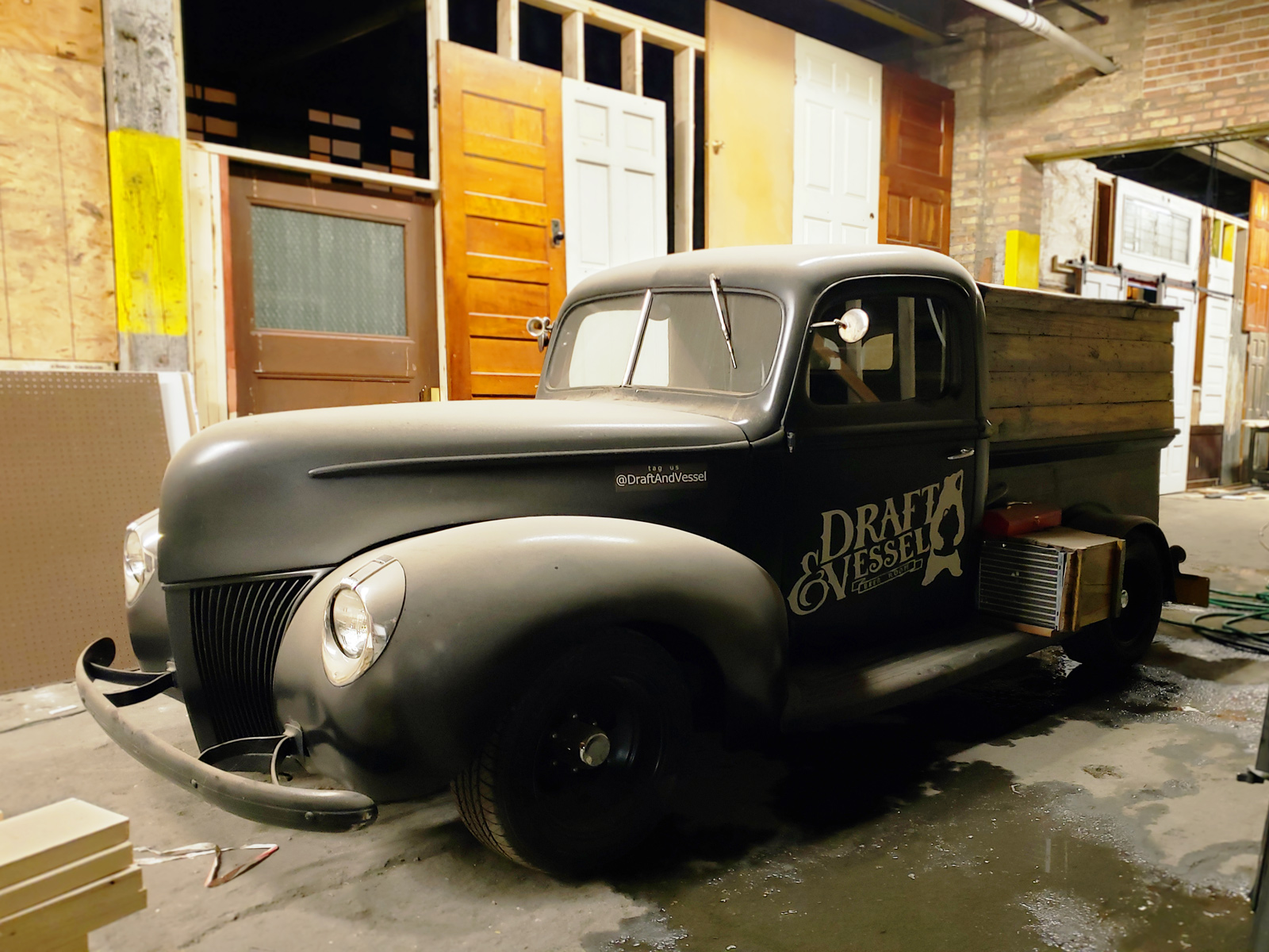 An vintage truck painted with the Draft and Vessel logo.