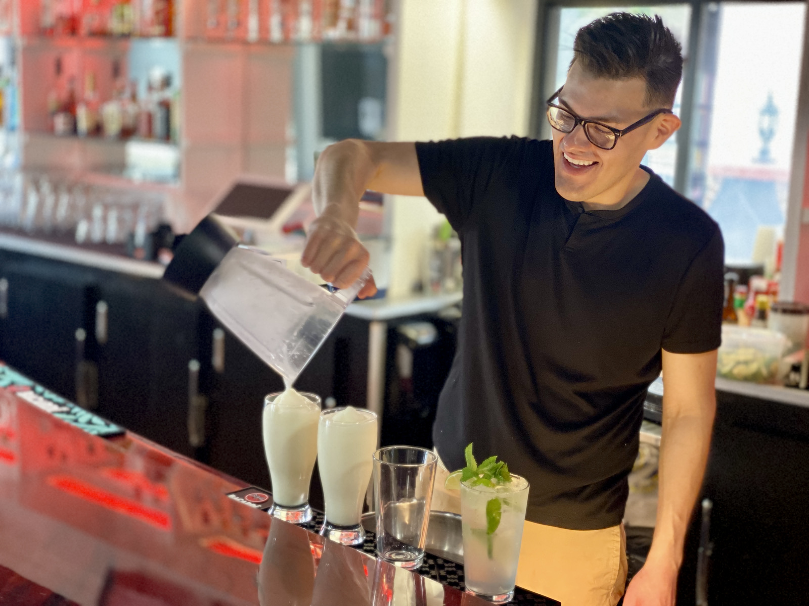 Jose Escobar pours drinks at the bar