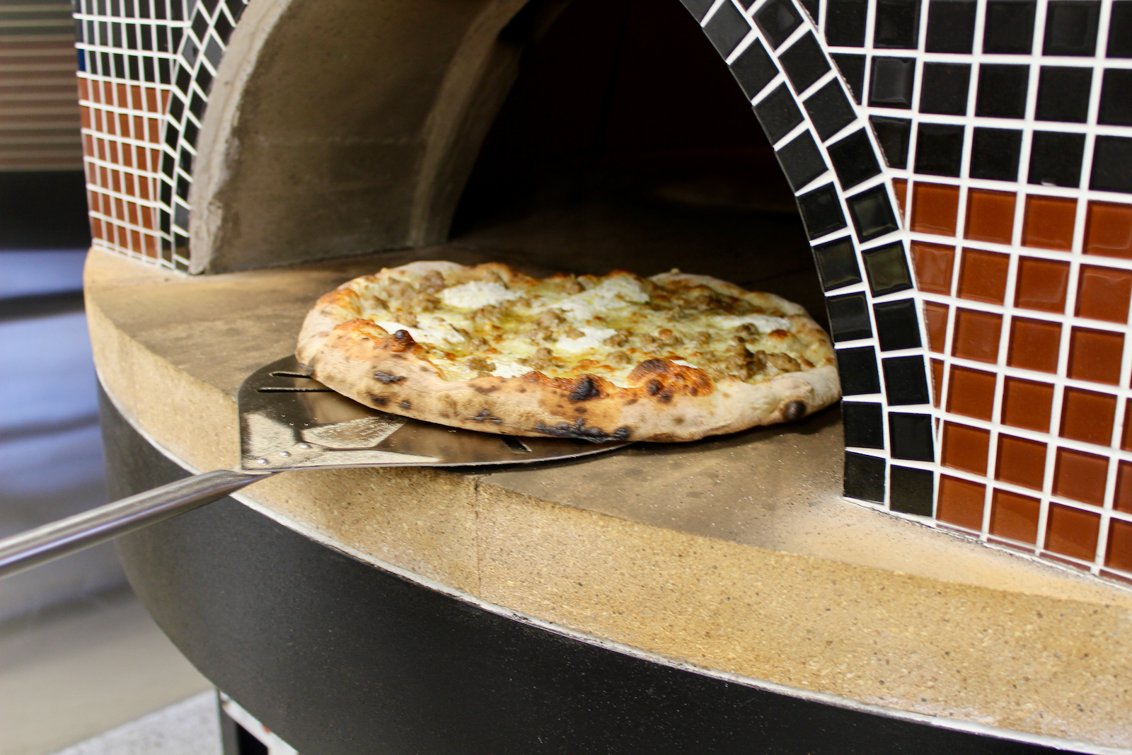 Wy'East pizza going into the gas-fired oven