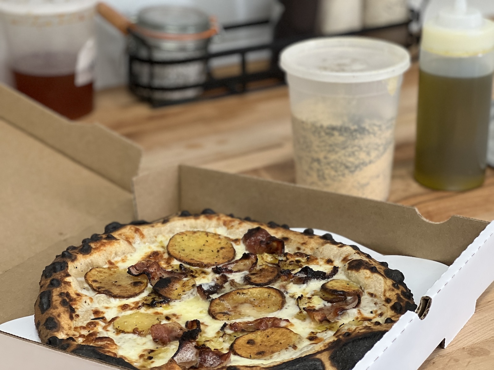 Uncut pizza in carry-out box