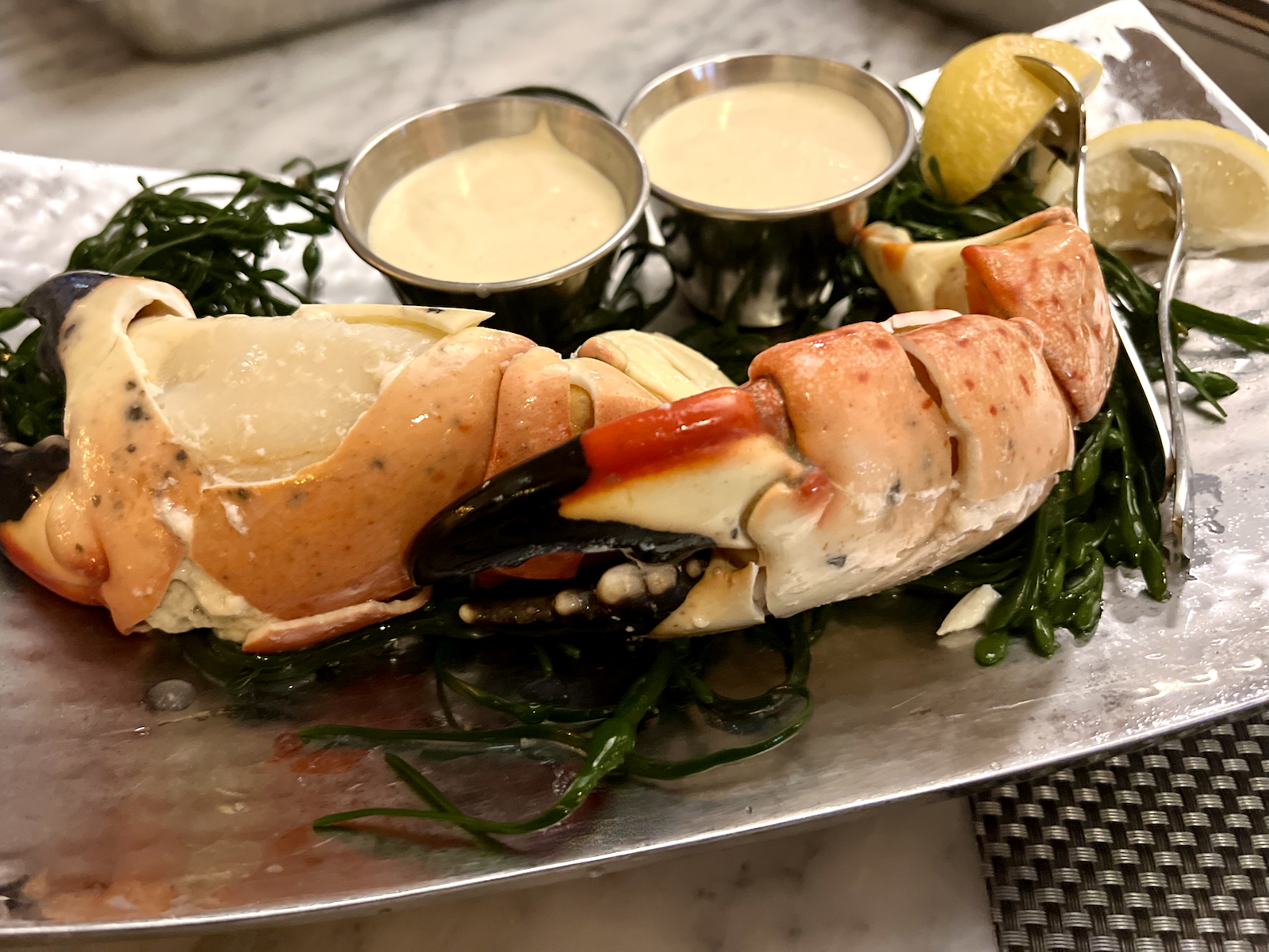 Two Stone Crab Claws with mustard sauce and lemon