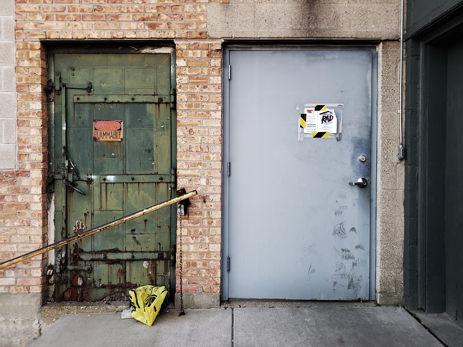 An original door that was decomissioned after a ramp was installed still stands next to the newer door.