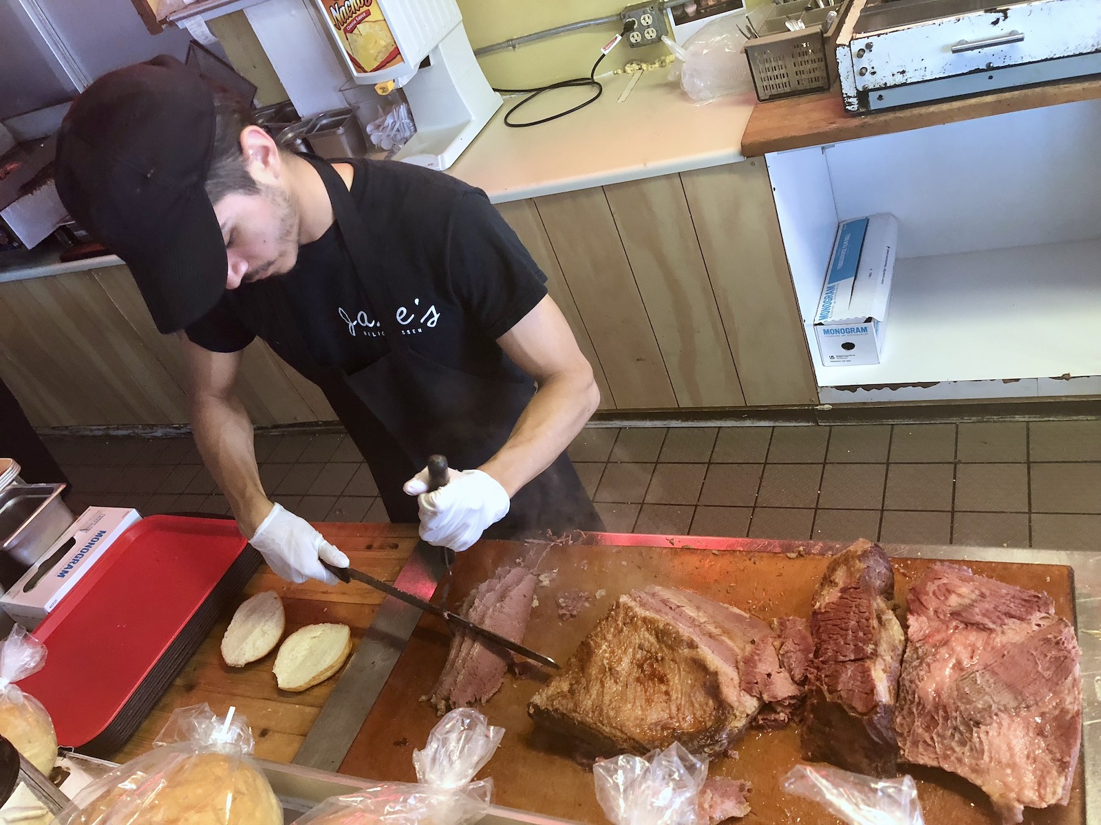 Employee cuts corned beef at Jake's Deli