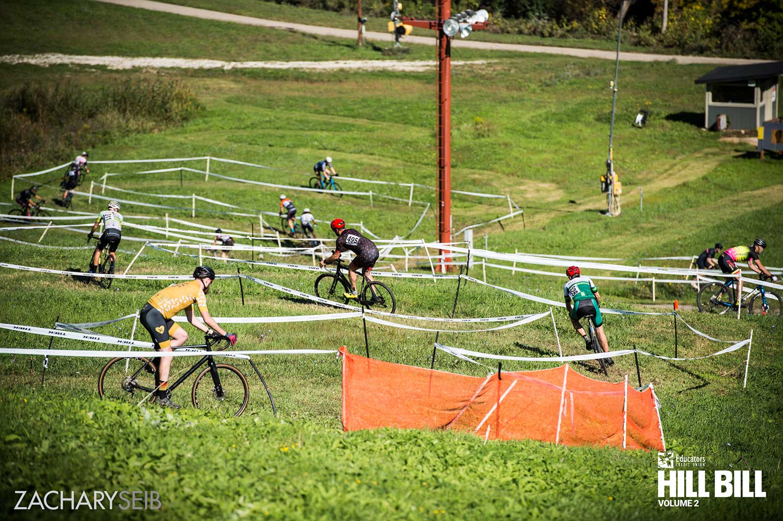 A group of cyclocross racers navigating a downhill descent.