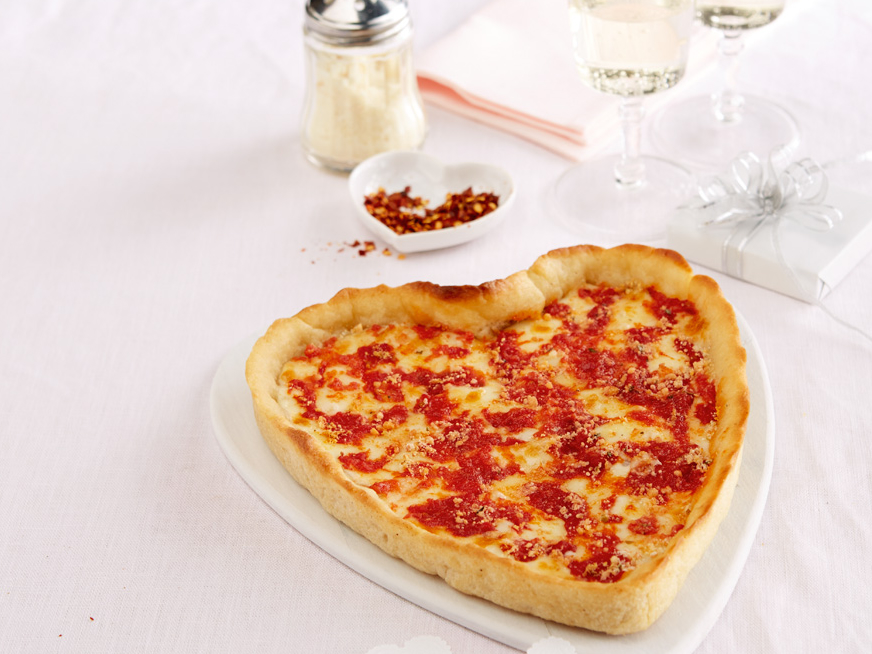 Heart Shaped Pizza on a white table cloth