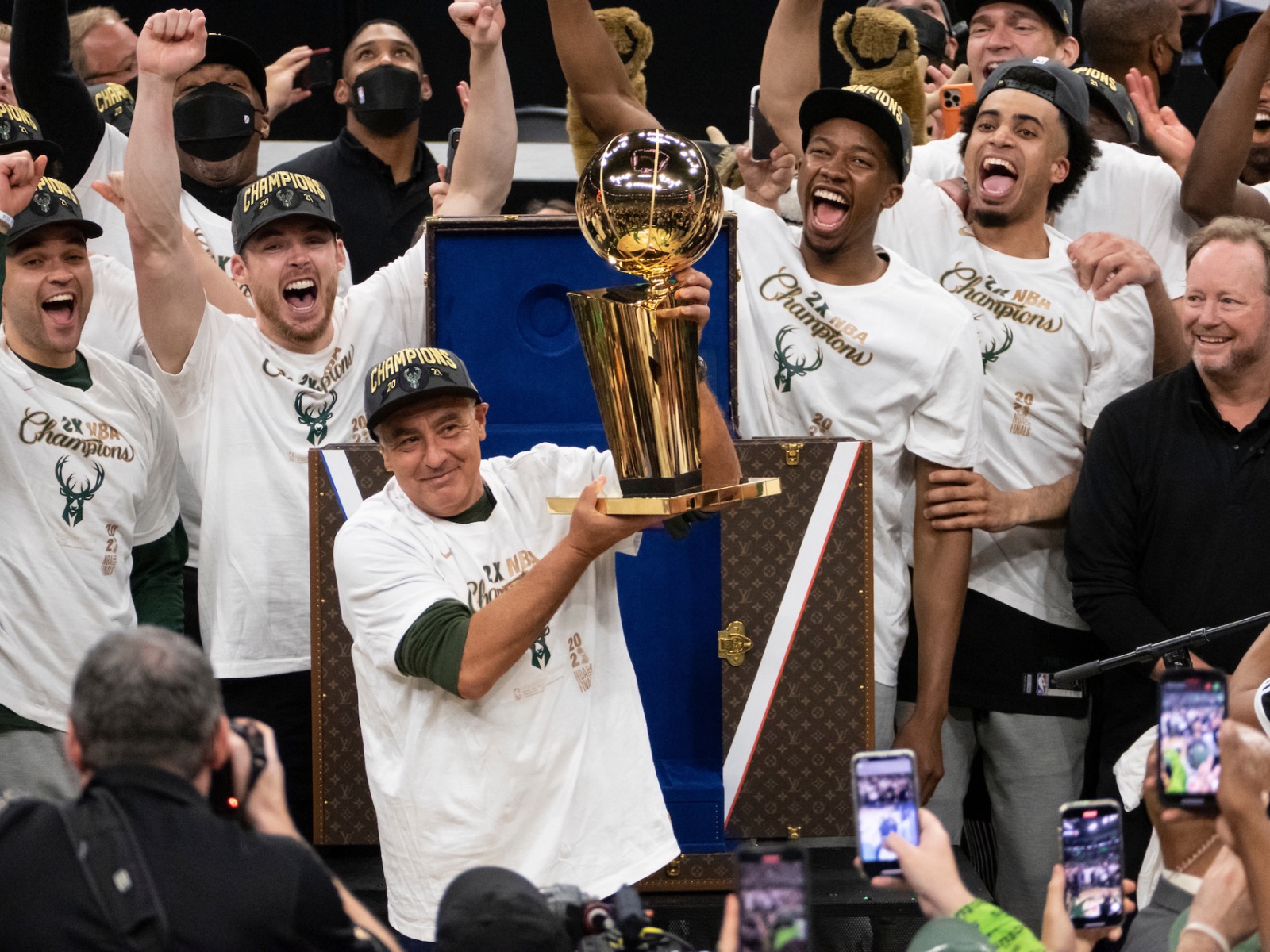 Milwaukee Bucks' Giannis Antetokounmpo holds up the NBA Championship trophy  and Finals MVP trophy to the crowd during a parade celebrating the  Milwaukee Bucks' NBA Championship basketball team Thursday, July 22, 2021