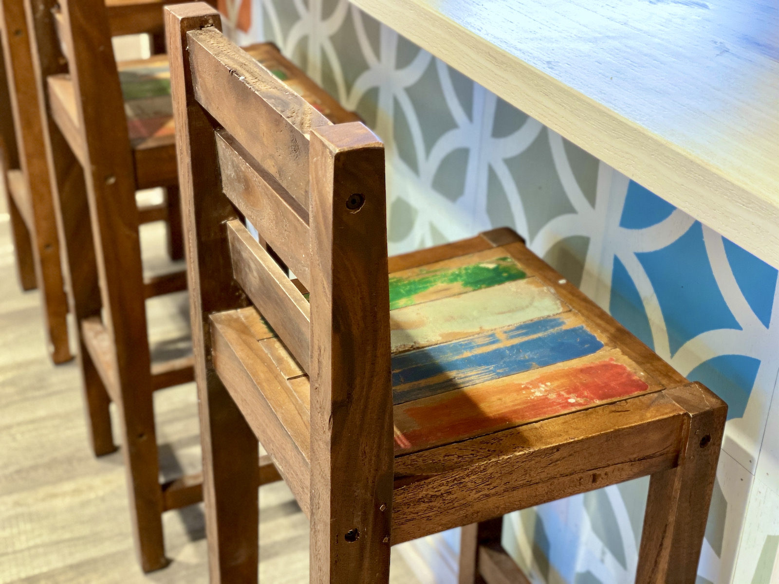 Rustic chairs against colored tile