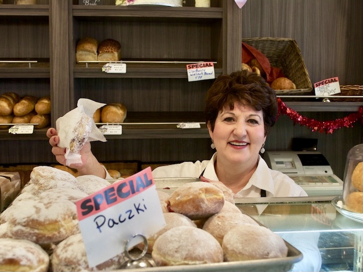 Friendly lady with paczki at Canfora Bakery