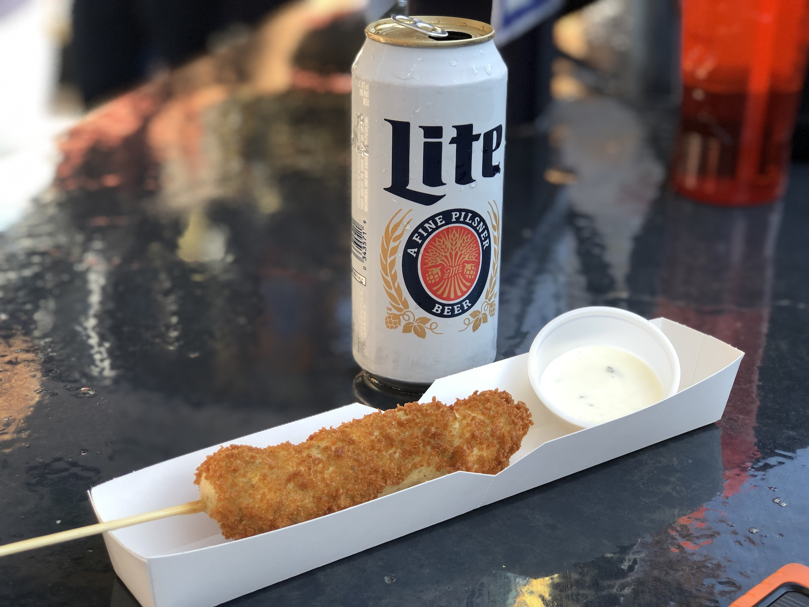 Deep fried olives on a stick with a Miller Lite