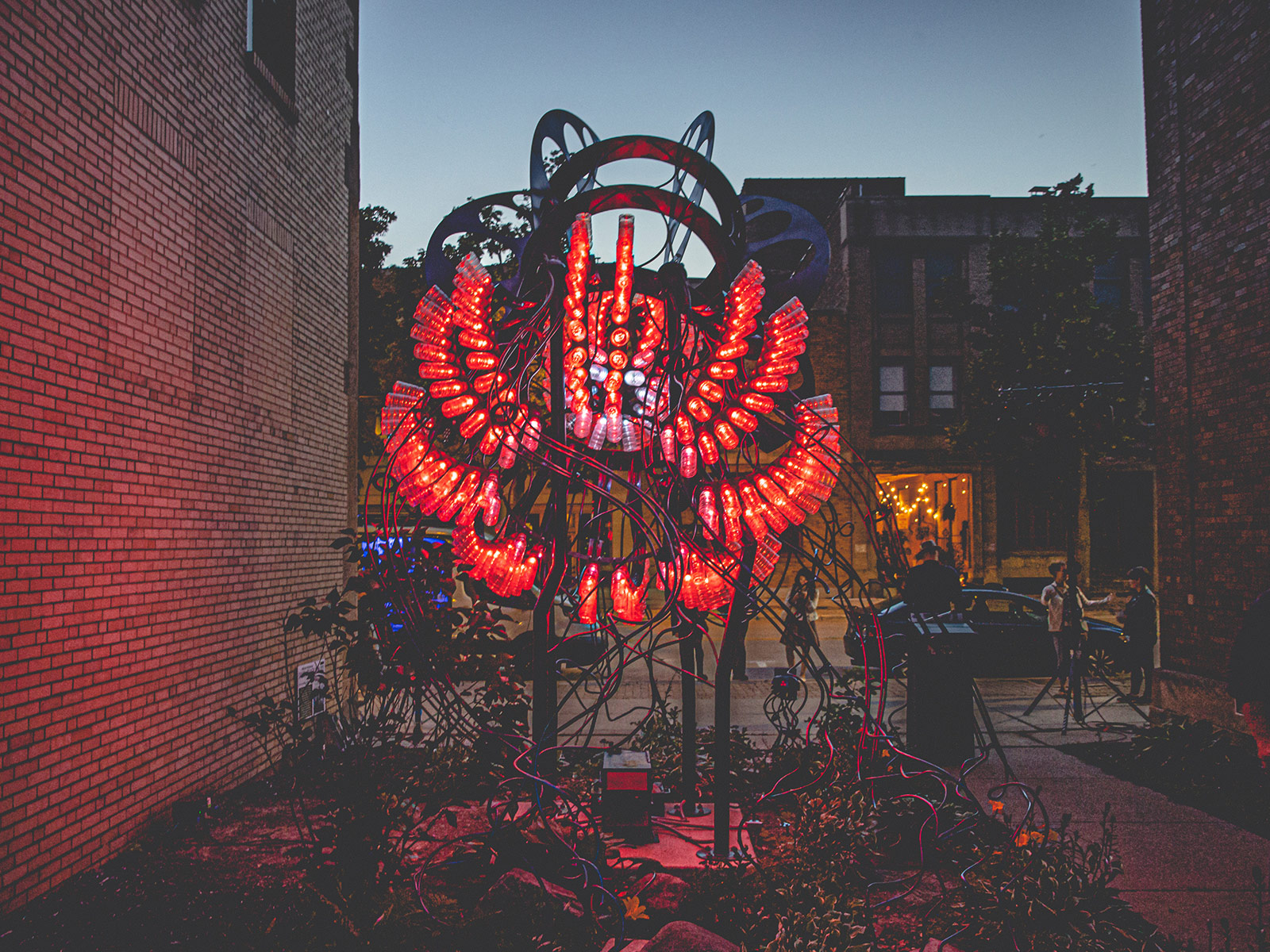 A midwest industrial jellyfish sculpture lit with red LEDs