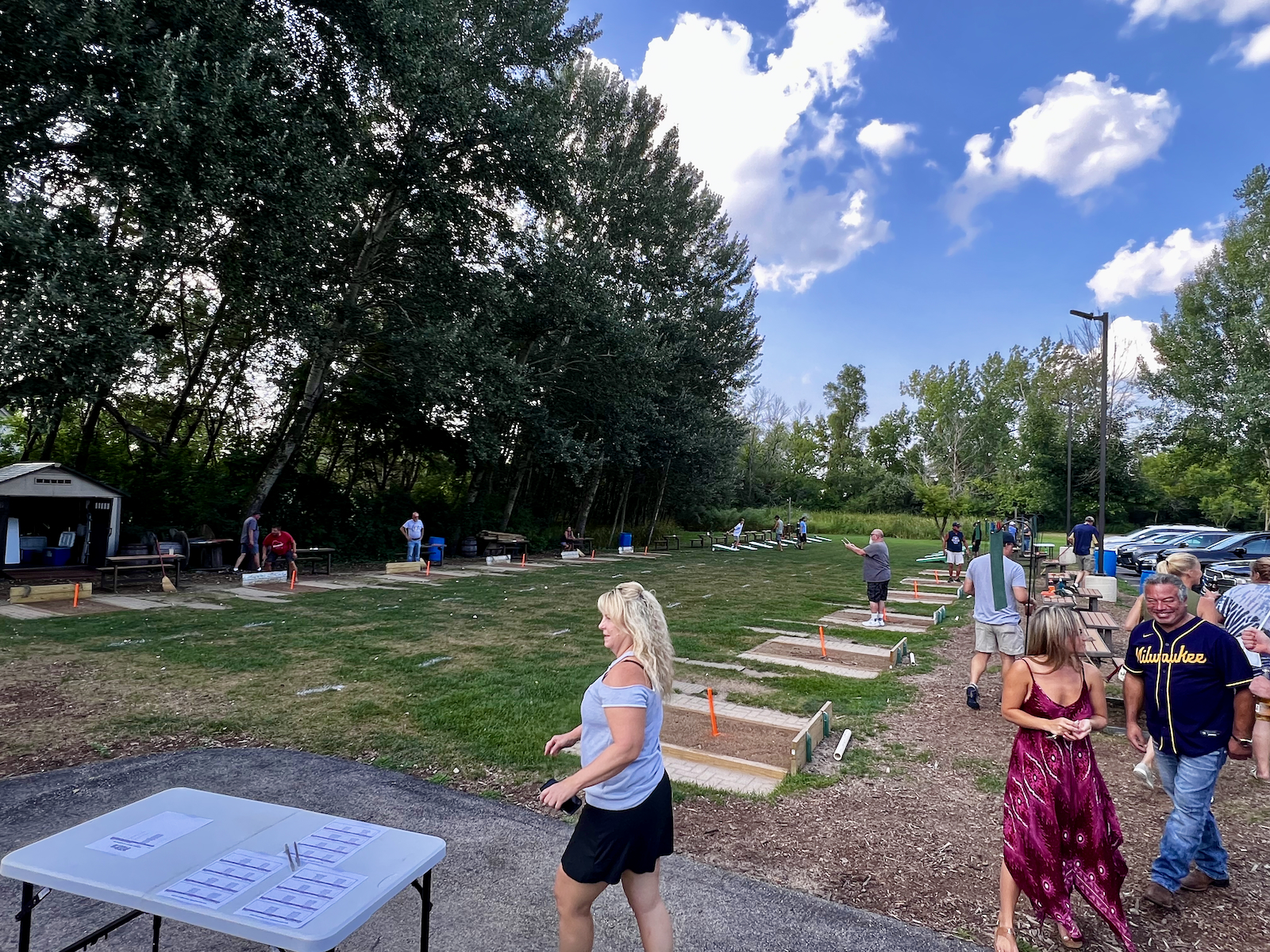 Folks playing horseshoes and cornhole