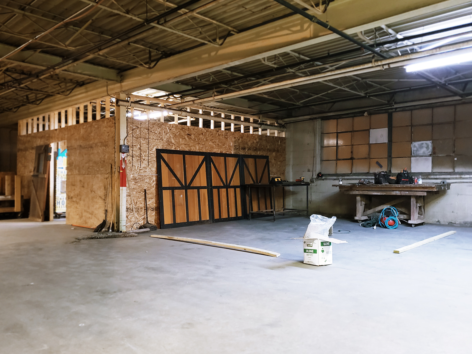 One studio space has been roughed in, while another is deliniated with two-by-fours.