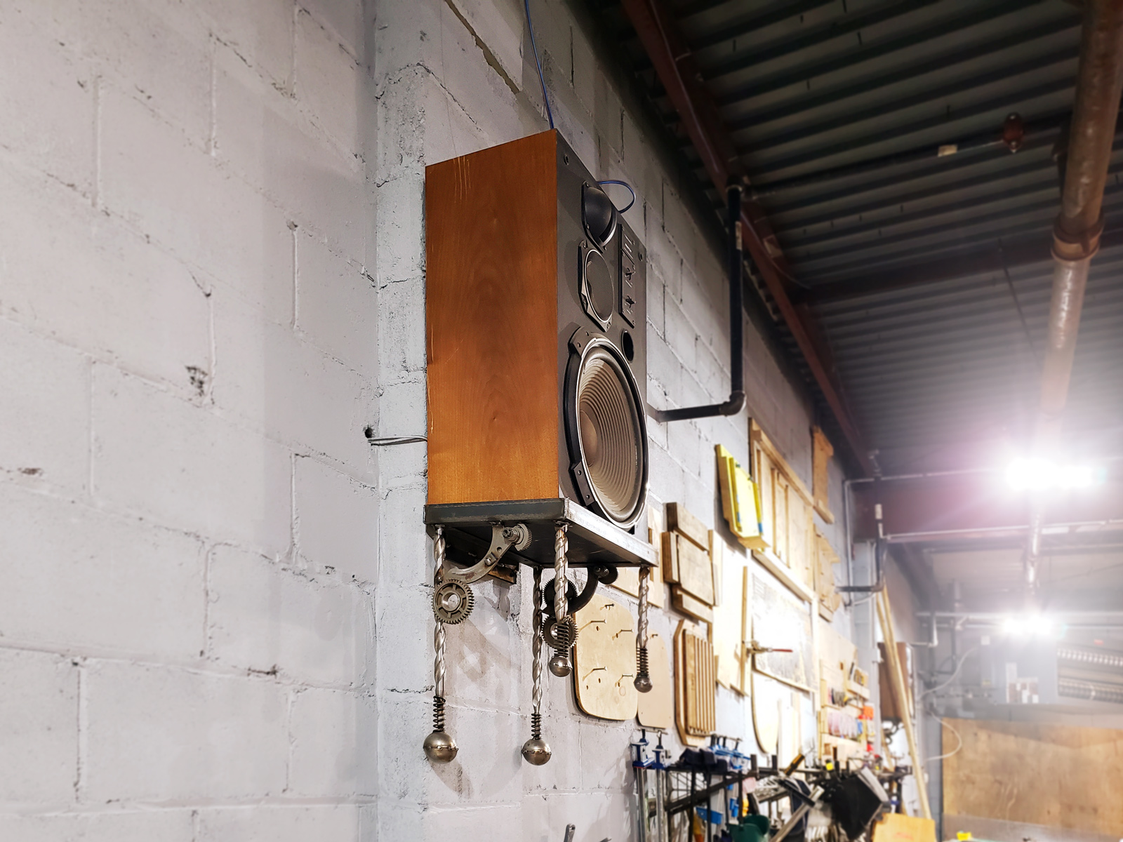 One of the finished speaker shelves, mounted on the shop wall.