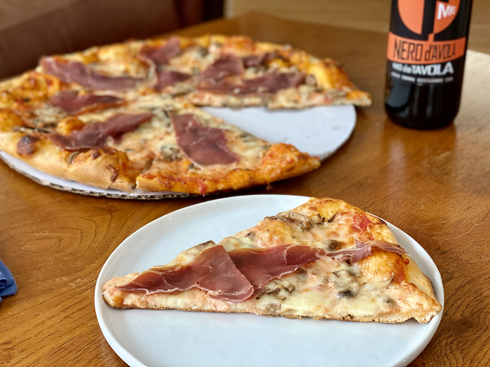 Transfer Pizzeria's Prosciutto Fungi pizza and house wine