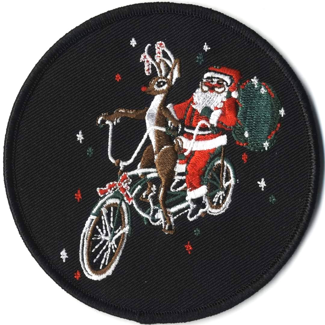 An embroidered patch featuring Rudolph the red-nosed reindeer and Santa on a tandem.