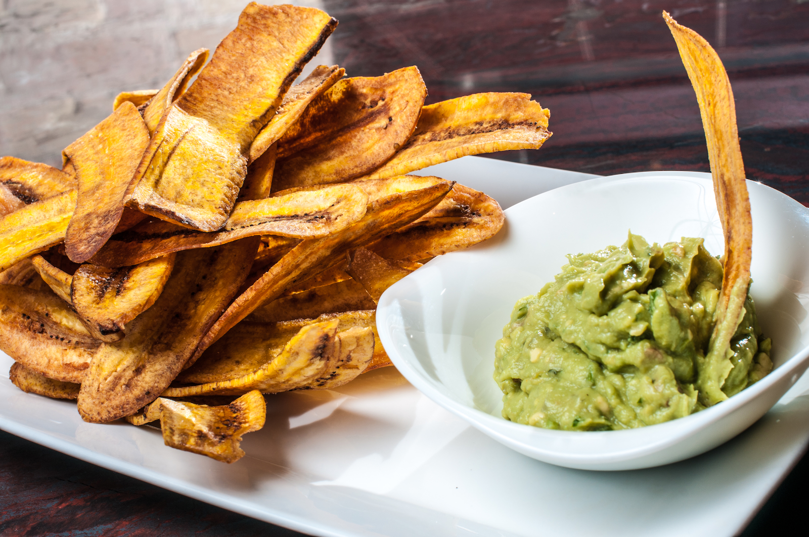 Nosh on Cubanitas famous plantain chips and guacamole.