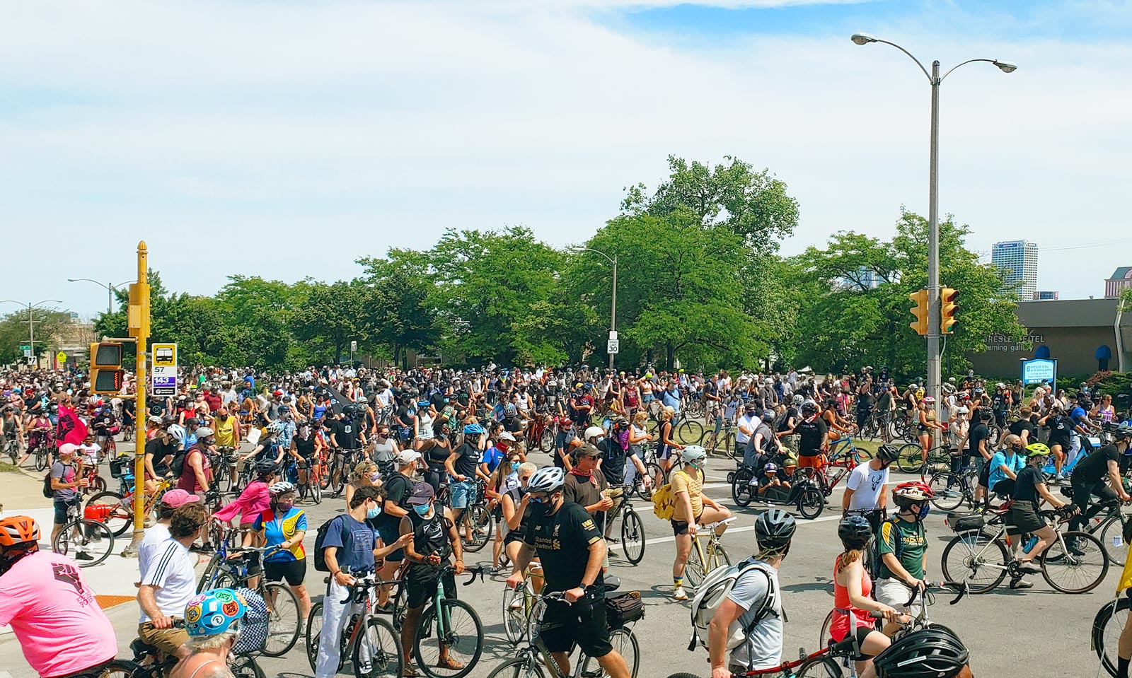 A massive group of people on bikes collecting at an intersection during a Black is Beautiful slow roll.