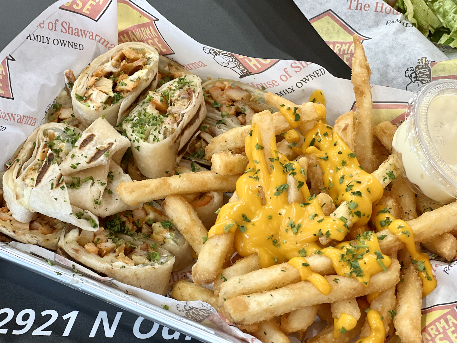 Chicken shawarma wrap with garlic sauce, and fries (with cheese sauce).