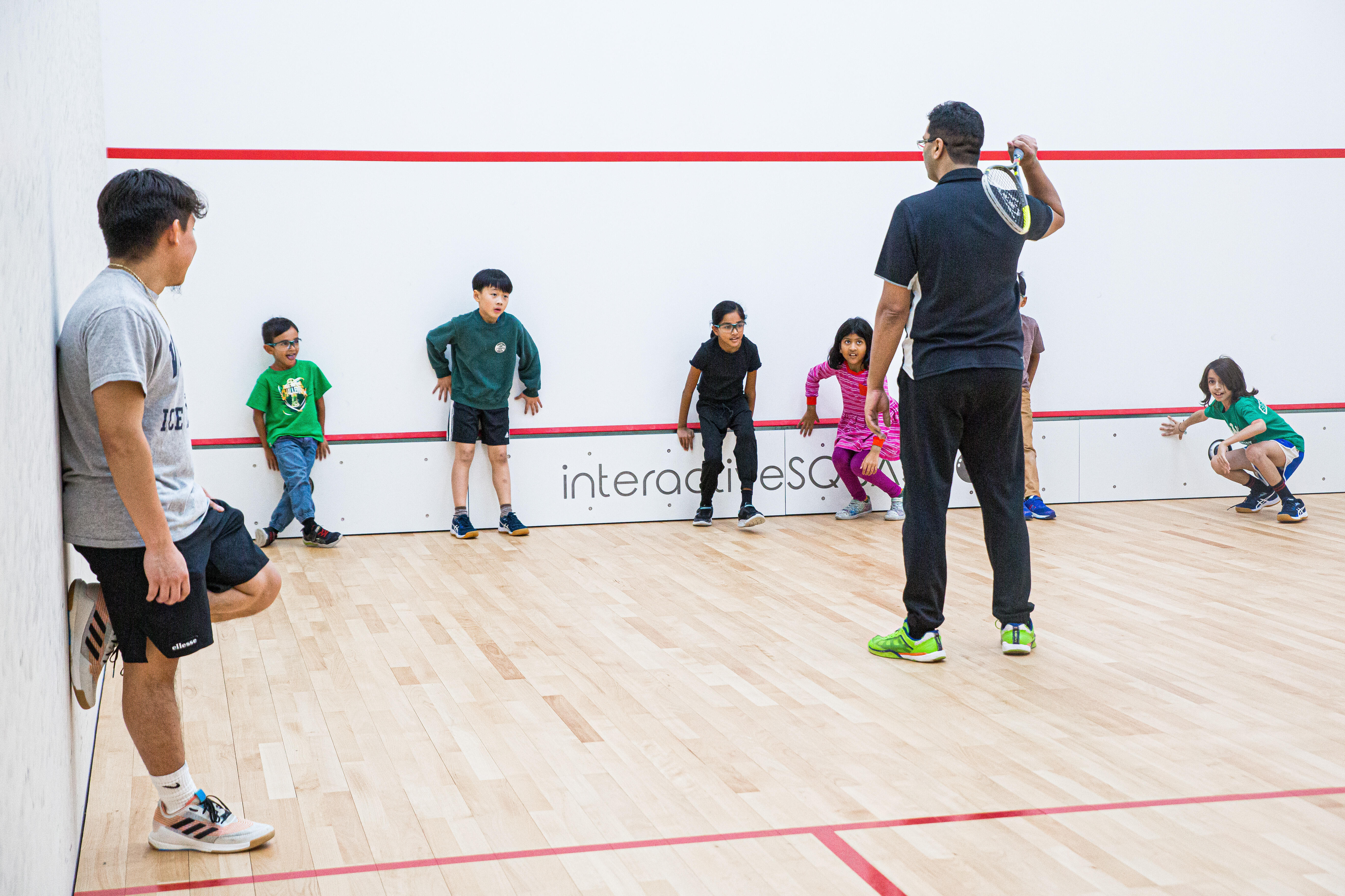 Asghar Abbas and Juan Santos on court with juniors at Bryant Park