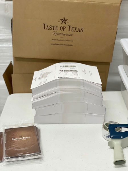 A stack of custom all-in-one fulfillment sheets for Taste of Texas