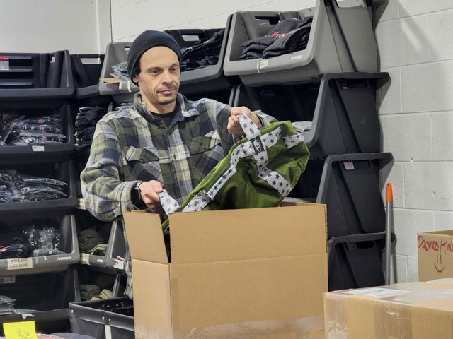 Brute Force employee packing a box with a product