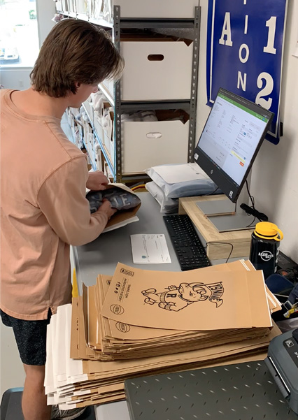 19nine employee packing an order