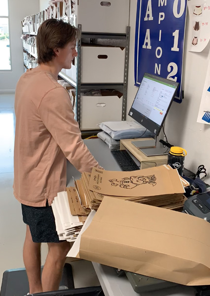 19nine employee creating a shipping label based on the weight of the package