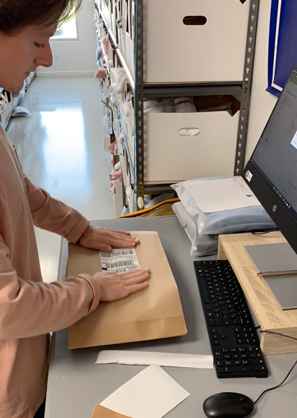 19nine employee placing shipping label on package