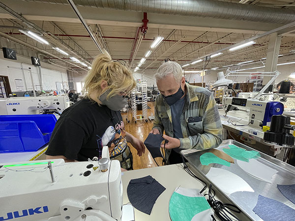 Kitsbow employees examining a face mask