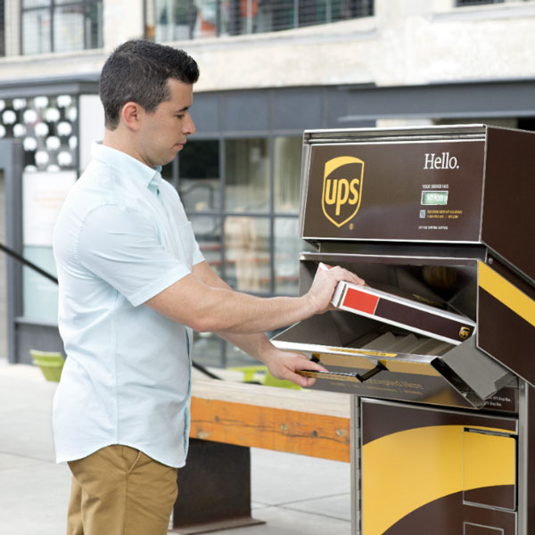 Man dropping off a package at a UPS dropbox