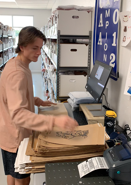 19nine employee grabbing the printed shipping label