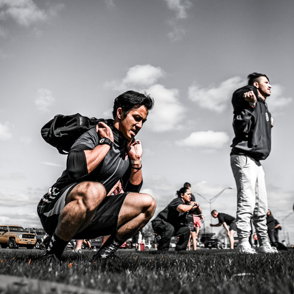 A group of people working out with Brute Force equipment outside