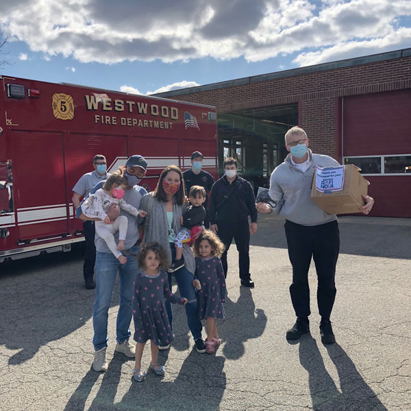 The Goldstein family with a fire department they donated masks to