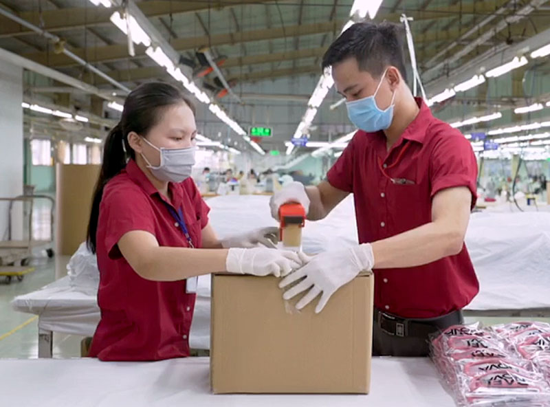 Workers in the Rafi Nova warehouse packaging up a box