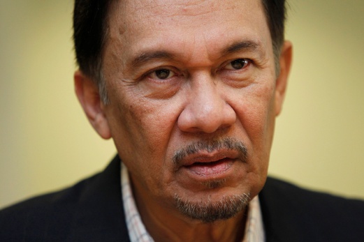 In this file photo, Datuk Seri Anwar Ibrahim pauses as he speaks to his assistants at a break session during his sodomy trial in Kuala Lumpur February 14, 2011. Anwar will have to serve out his remaining 16 months of his five-year jail sentence after the Federal Court dismissed his review application to set aside his sodomy conviction today. Reuters Photo