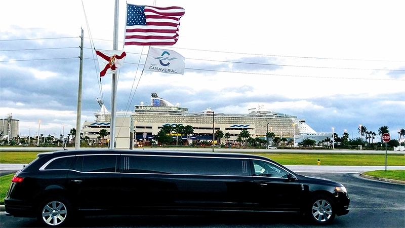 Cruise ship docked at a Port Canaveral terminal with a black stretch limo out front