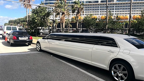 Cruise ship docked at a Port Canaveral terminal with a white stretch limo out front