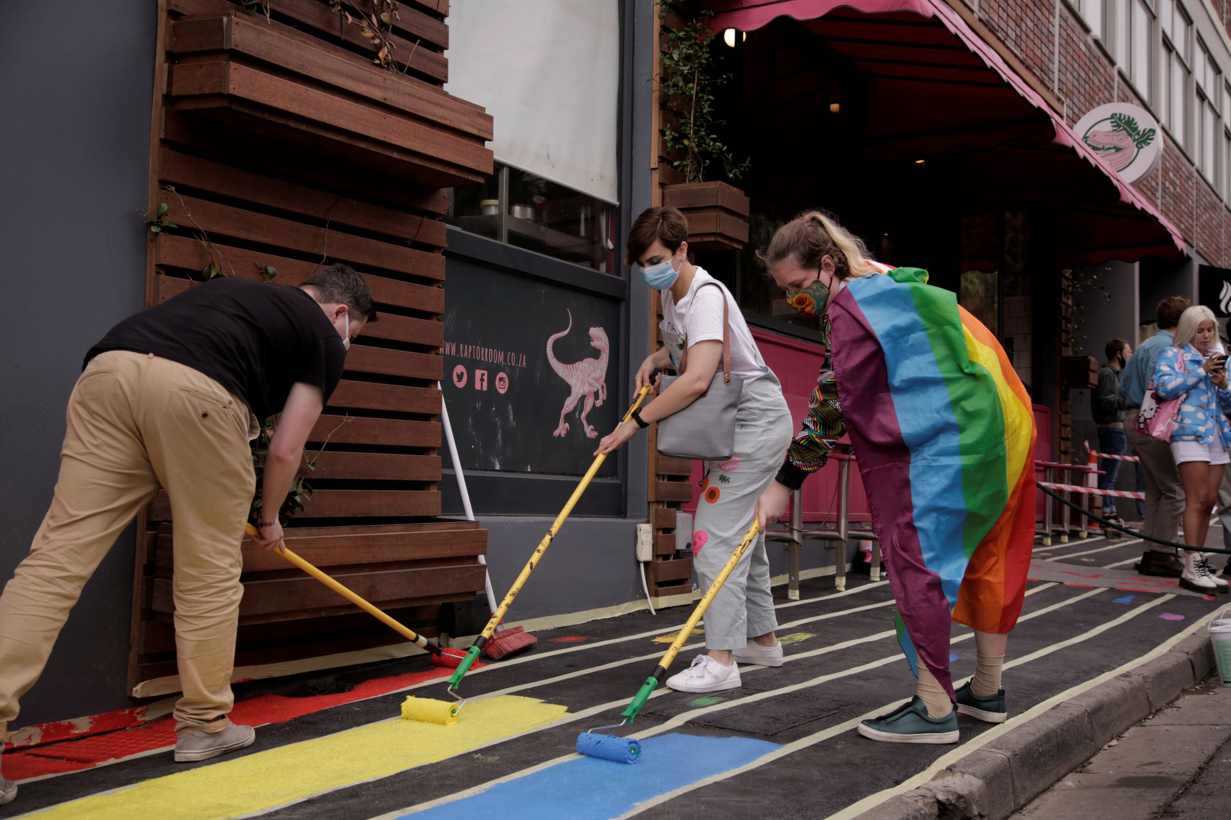 girl painting with pride flag