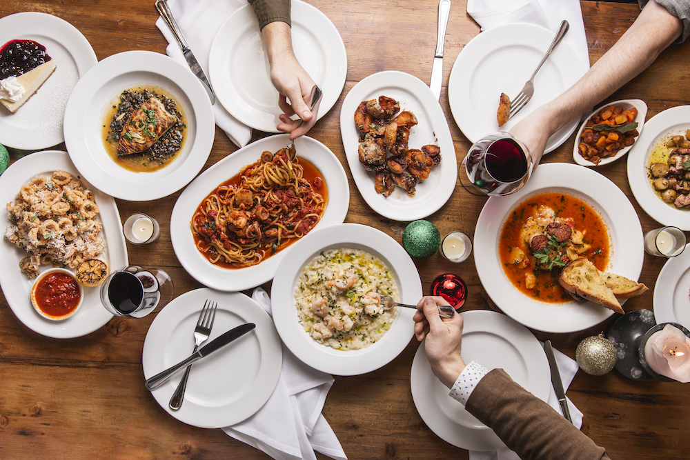 An overhead view of menu items from the Feast of Seven Fishes at Osteria Via Stato.